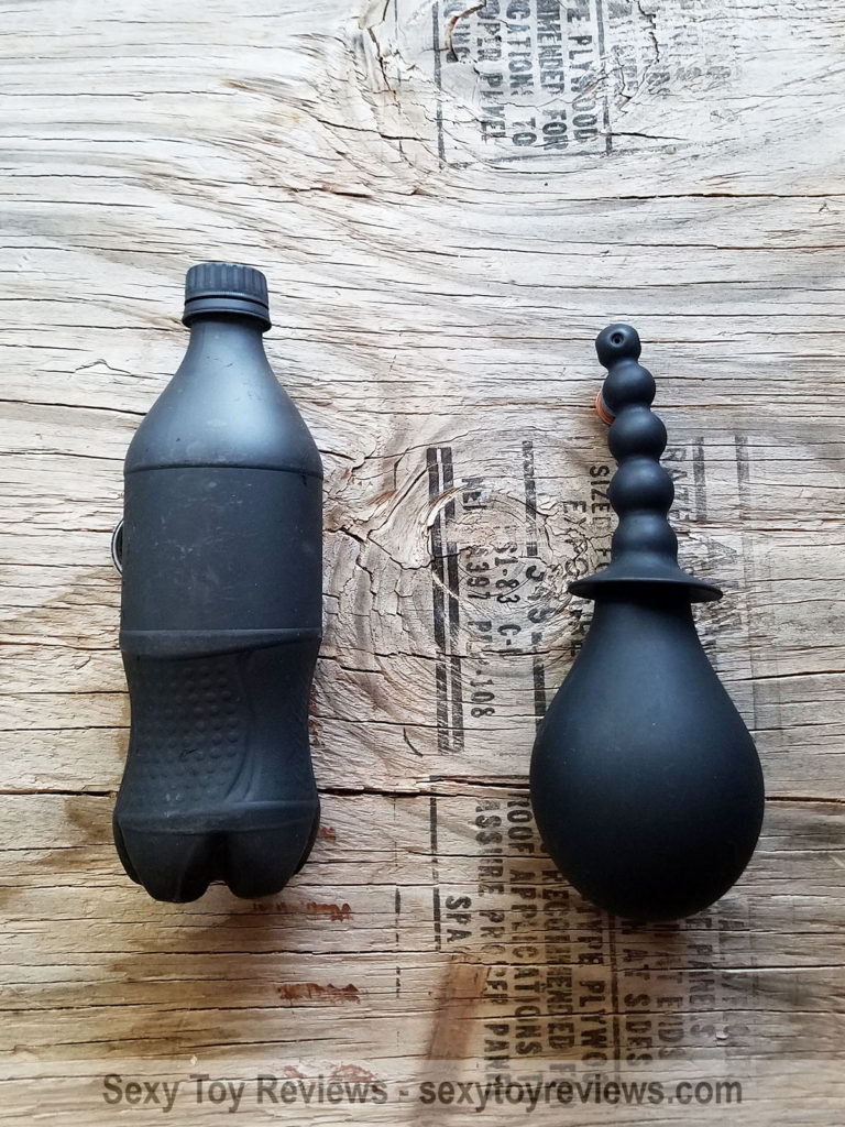 All silicone enema bulb pictured next to a standard US 20oz cola bottle