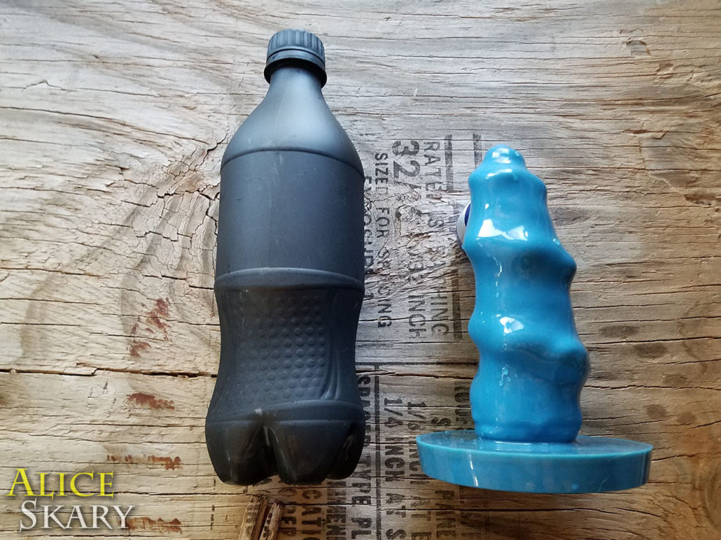 size comparison next to a cola bottle