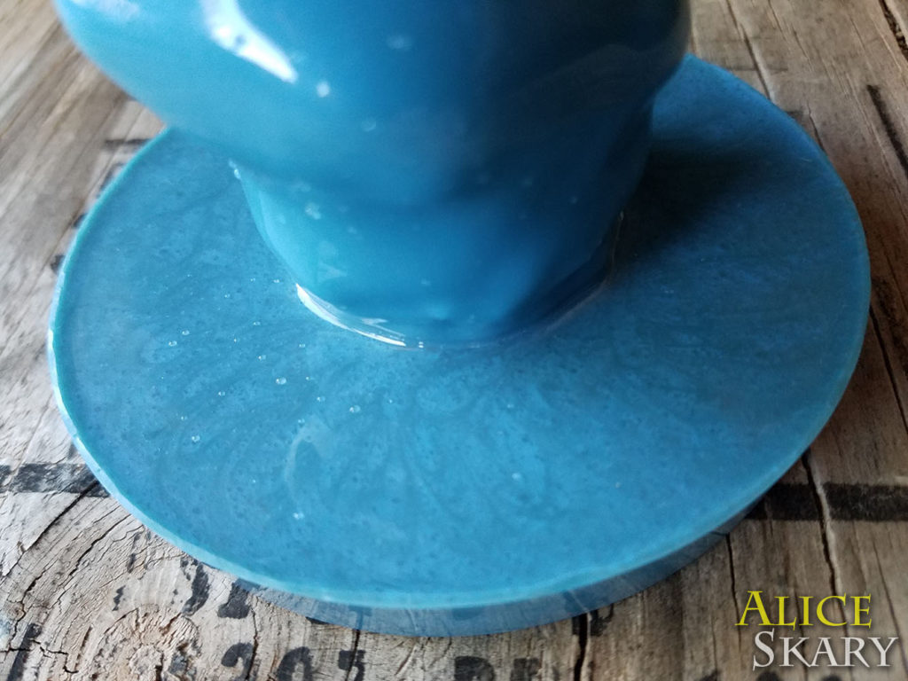 A blue dildo with a suction cup flared base