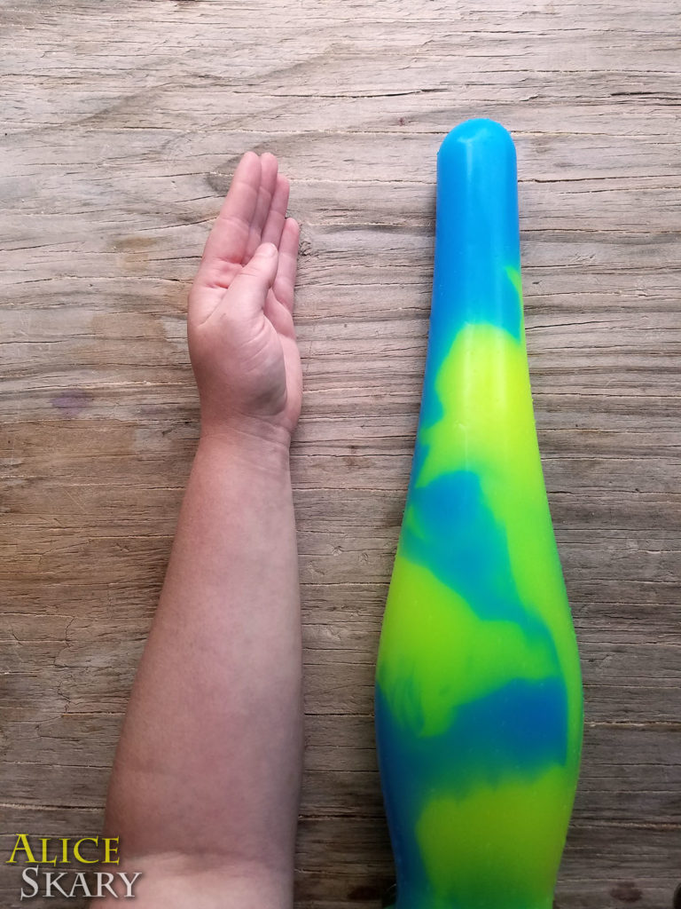 The "Intense" silicone dildo is pictured next to a forearm